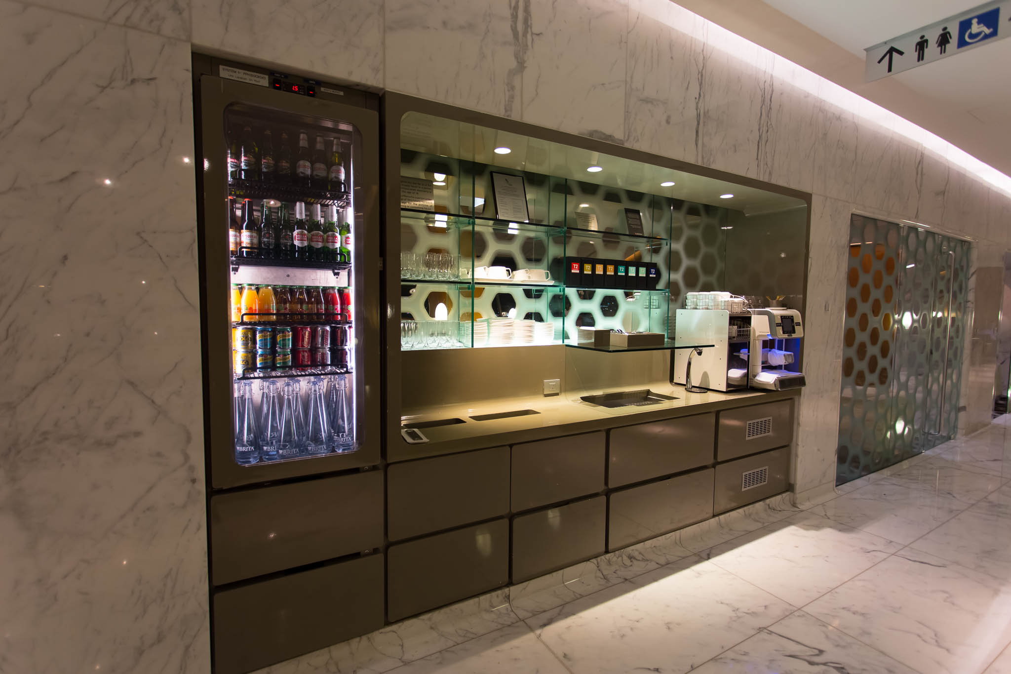 a glass display case with drinks in it