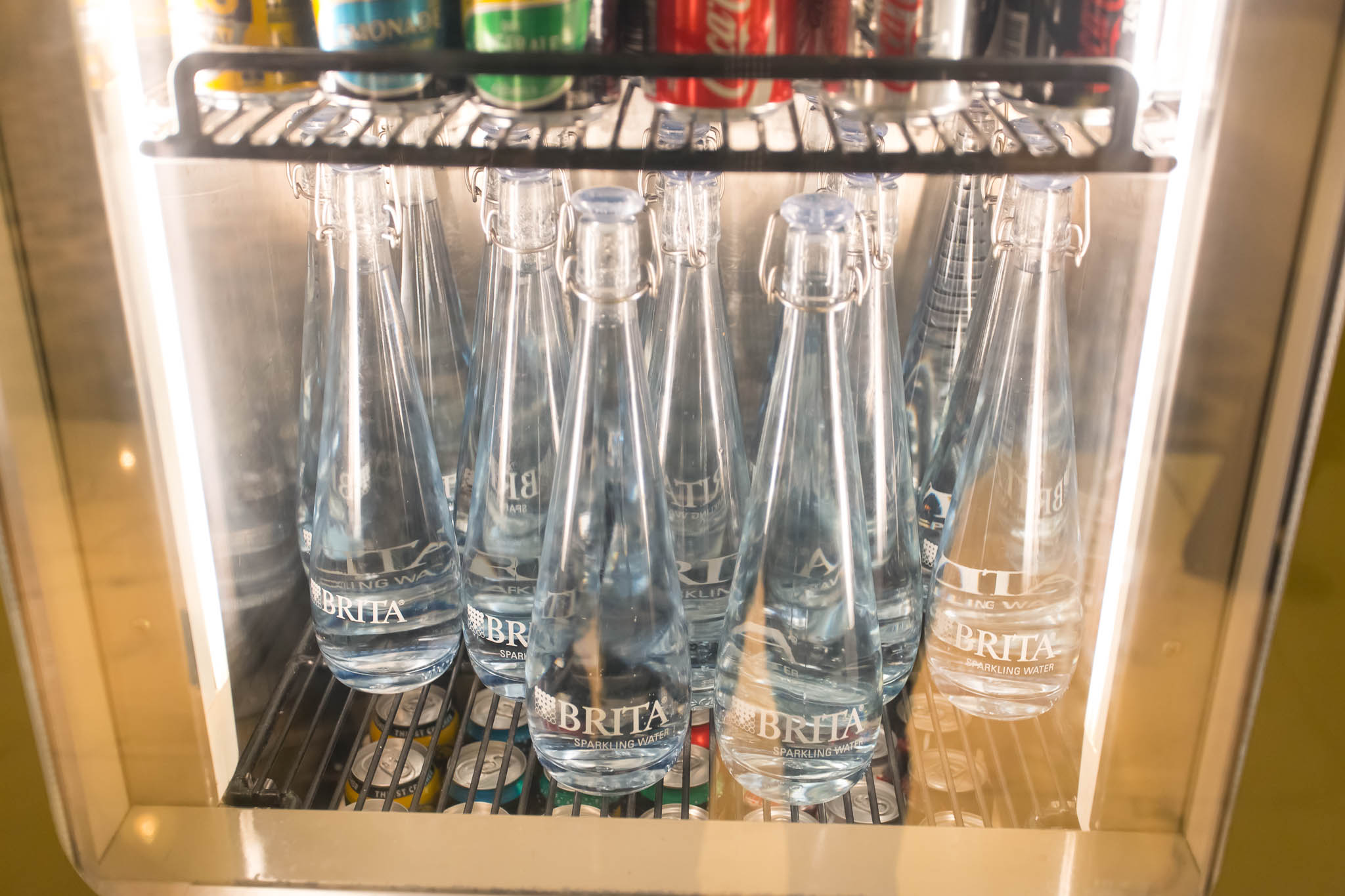 a group of bottles in a fridge