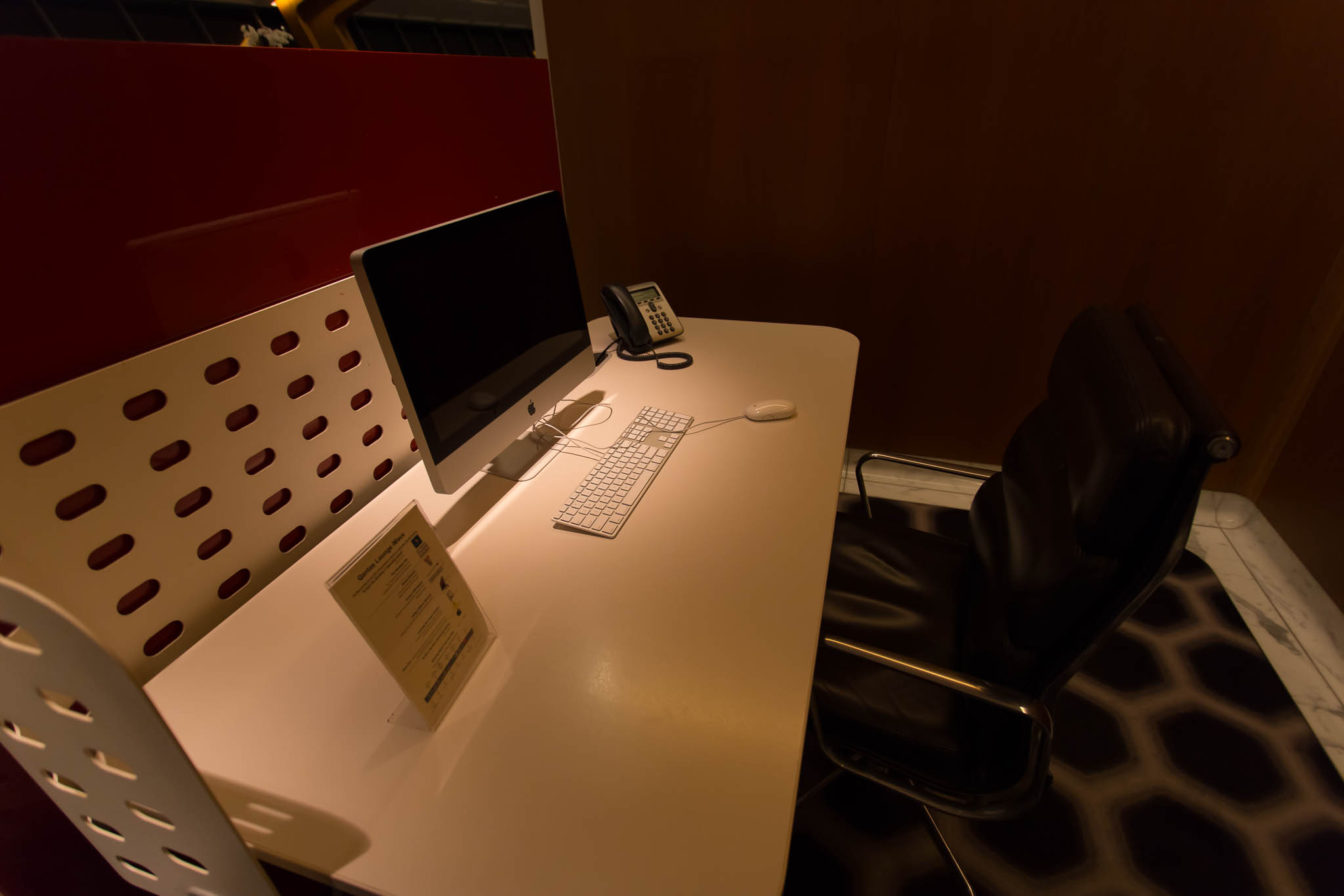 a desk with a computer and a phone