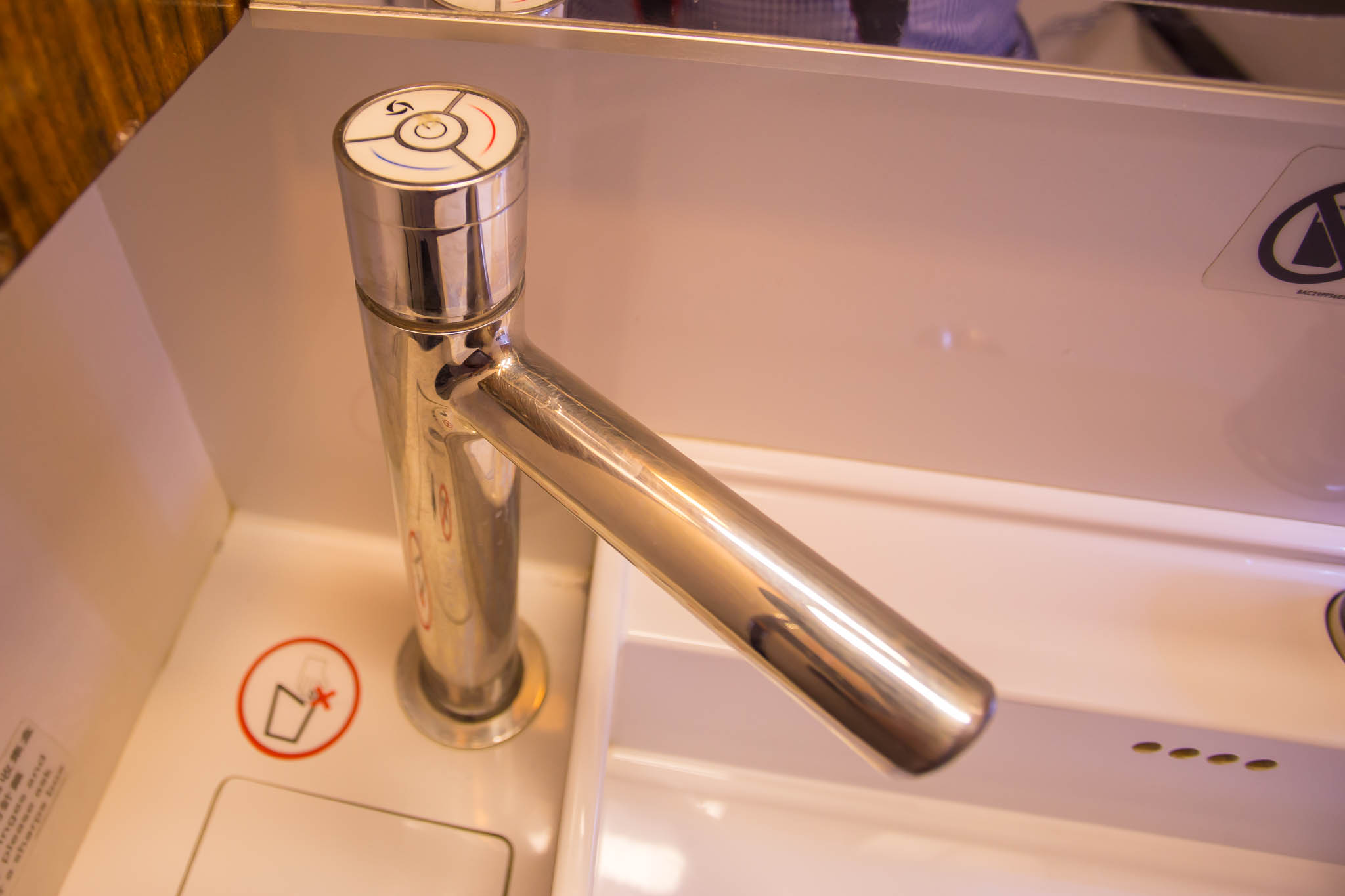 a silver faucet with a white surface