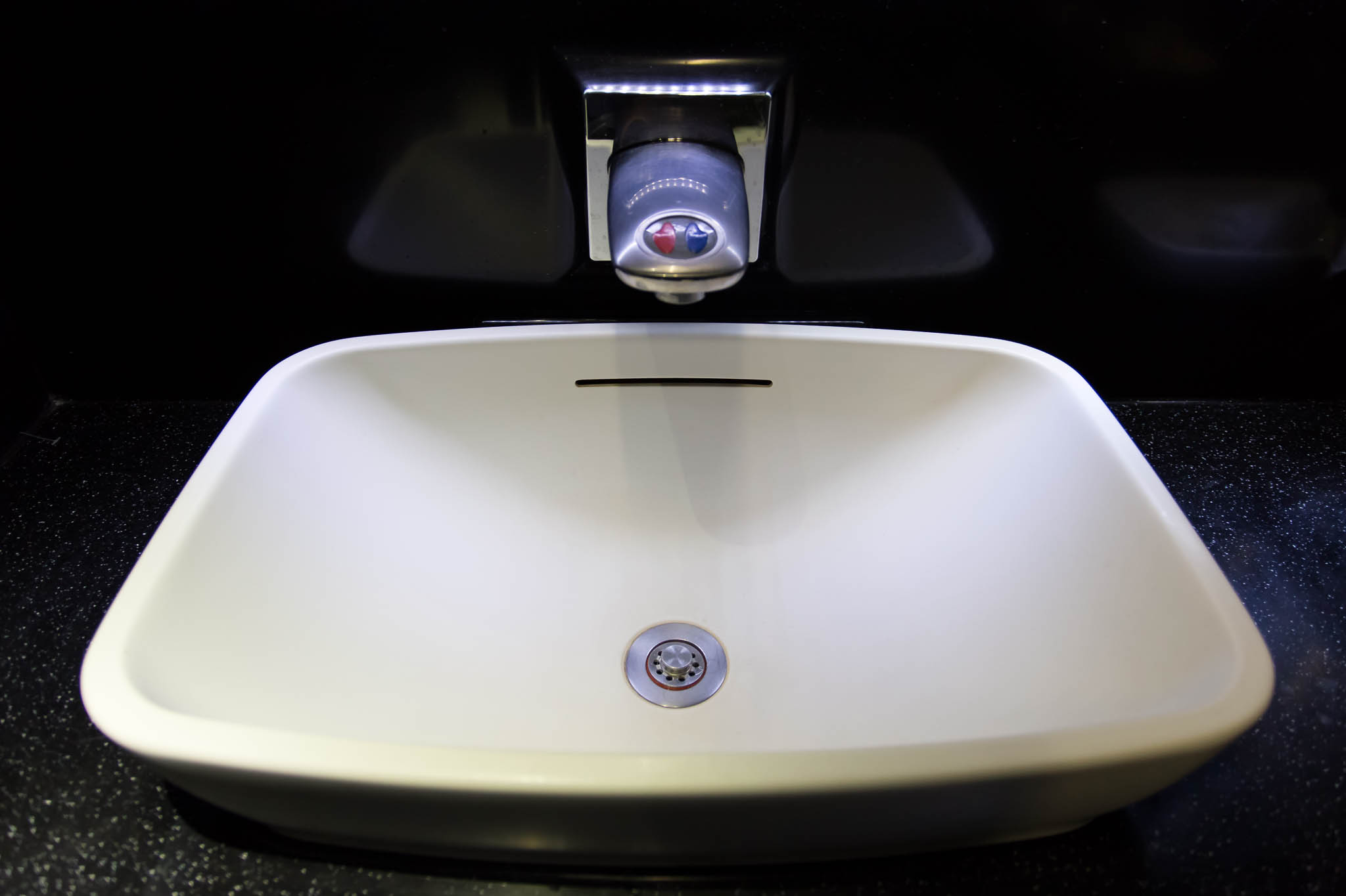 a white sink with a faucet