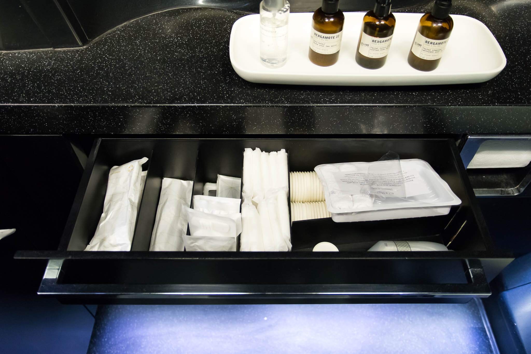 a black drawer with a tray of toiletries and a tray of toiletries